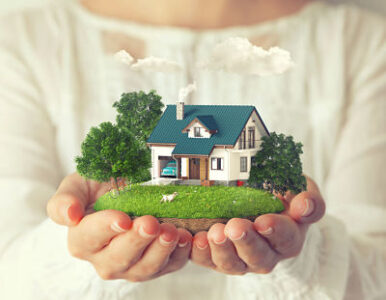 Small fantastic island with a house and backyard in women's hands.